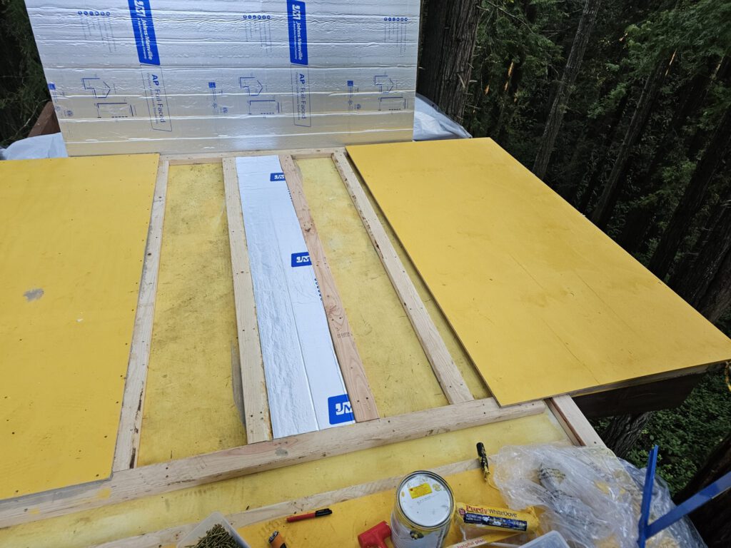 Installing the subfloor. Foam insulation between 2x4 sleepers. A sandwich.